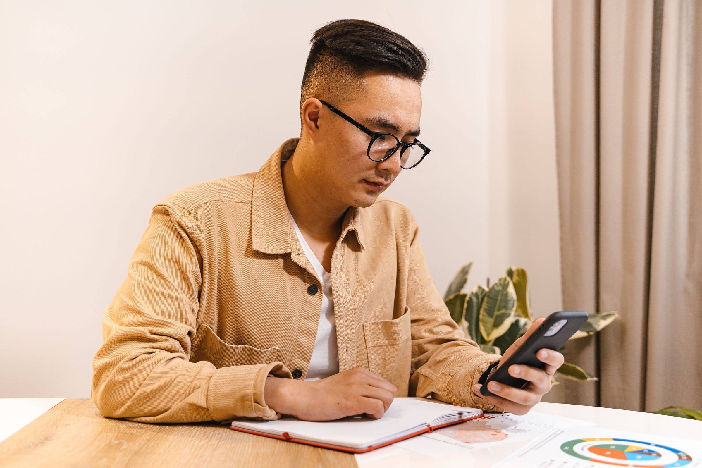 Employee using a phone to make a confidential report at his desk